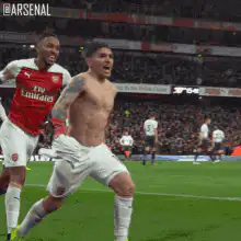 Alexandre Lacazette celebrates shirtless with teammate