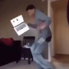 Man dancing with laptop