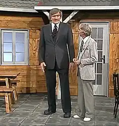 Giant man bows to small man