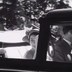 Queen Elizabeth II waving from a car