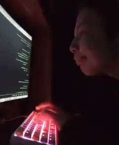 Person typing on RGB keyboard