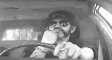 Snoop Dogg driving and pointing
