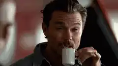 Matt Damon drinking from a small cup