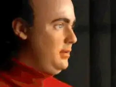 Bald man in red shirt smirks