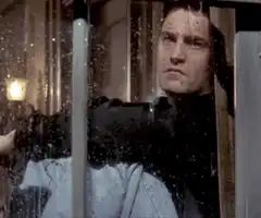 Man looking through dirty window
