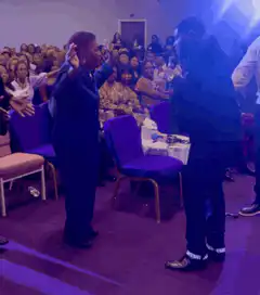 Man dancing on stage with audience