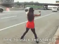 Woman dancing on highway shoulder