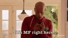 Bald man in red hoodie dancing in kitchen
