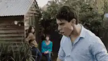 Man slapping people at a party