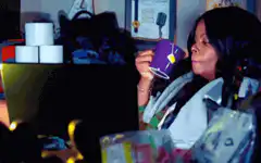 Woman drinking from purple mug