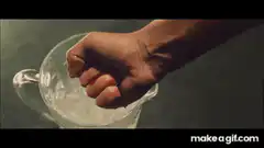 Hand crushing glass in water