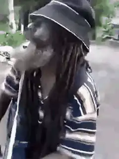man smoking with long dreadlocks