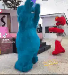 Cookie Monster and Elmo dancing