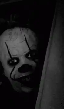 Pennywise peeking from behind a wall