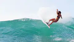 Woman surfing a large wave