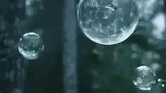 Glass bubbles floating and shattering