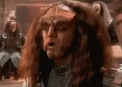 Worf reacts with shock and anger