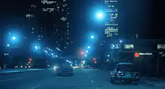 Night city street with cars and blue lights