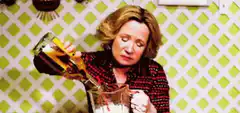 Woman pouring wine into a measuring cup