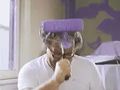man painting ceiling with roller on head