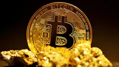Bitcoin coin on gold nuggets