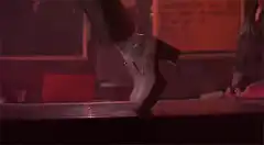 Woman's boot tapping on a bar counter