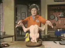 Woman holding a raw chicken