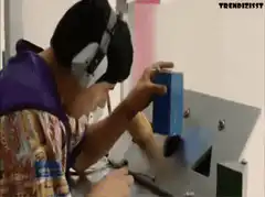 Man tries to fit square box in triangle hole