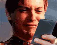Tobey Maguire squinting at phone