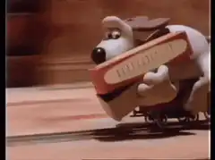 Gromit rides a toy train