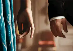 Two hands slowly reaching for each other