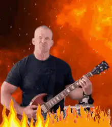 Man playing guitar in front of fire