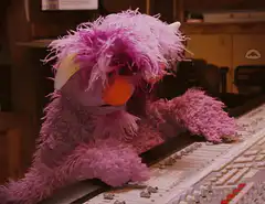 Rosie the purple Muppet at a mixing board