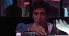 Tony Montana smoking a cigar