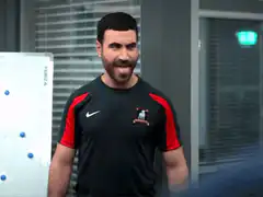 Man in black and red shirt making faces