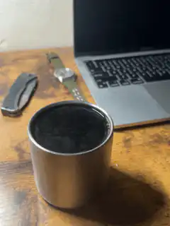 steaming metal cup on desk