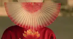 Woman opens fan to reveal face