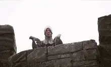 Man in stone wall making heart shape