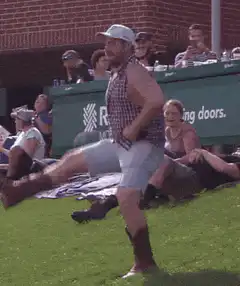 Man in cowboy boots dancing at a baseball game