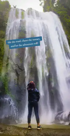Woman standing before a waterfall with travel quote