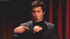 Andy Samberg pointing at himself