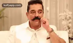 Man with mustache touching nose