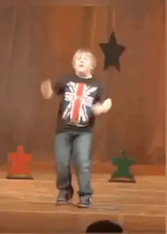 Young boy dancing on stage