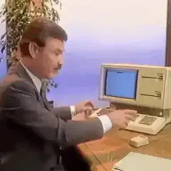 Man types on vintage computer
