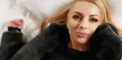 Woman lying in bed shushing