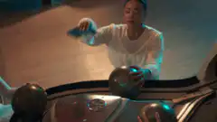Two women playing bowling in a retro arcade