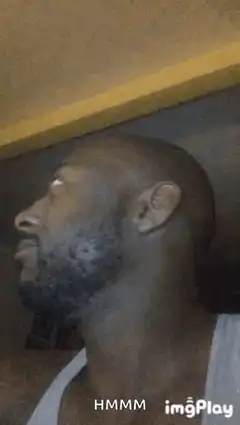 man turns head and smirks
