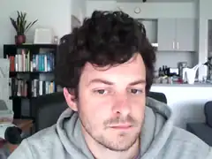 man with curly hair looking down