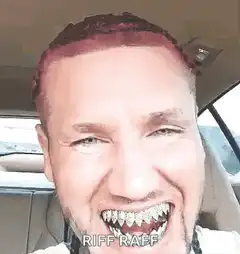 Riff Raff grinning in car