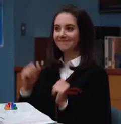 Lena Dunham smirking and dancing